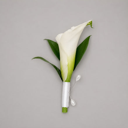 Devotion white calla lily boutonniere with white satin ribbon