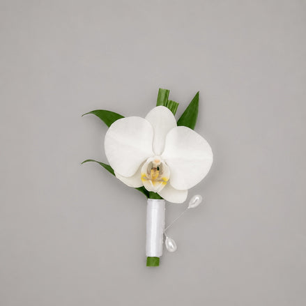 Élan white orchid boutonniere with white satin ribbon and pearl pins