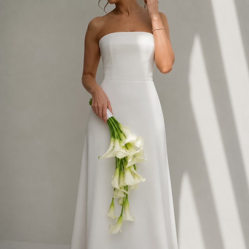 Ivory Falls cascading white calla lily bridal bouquet styled with a modern strapless wedding dress