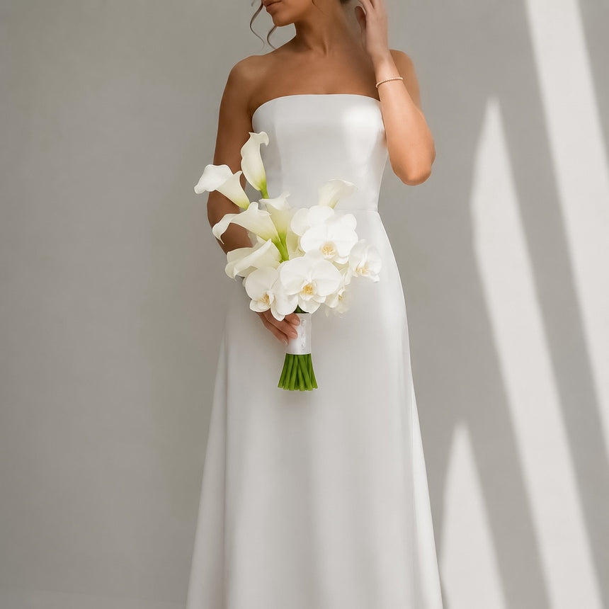Muse white calla lily and orchid bridal bouquet styled with a modern strapless wedding dress