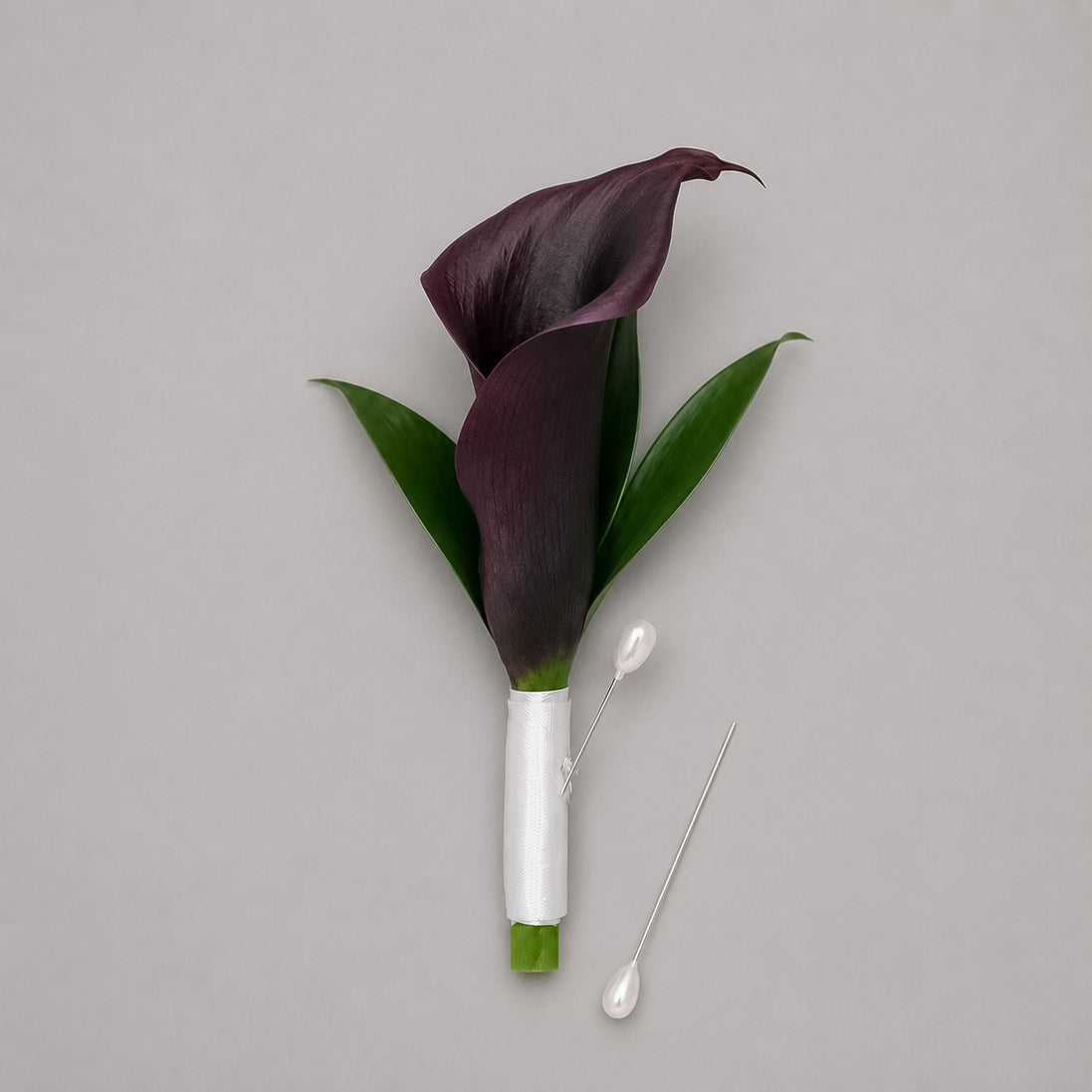 Velvet Night dark calla lily boutonniere with white satin ribbon