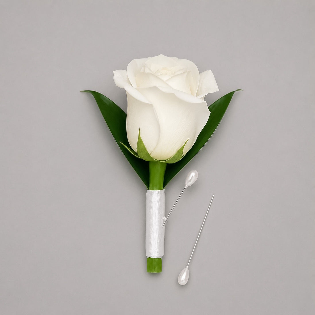 Vow white rose boutonniere with white satin ribbon and pearl pins